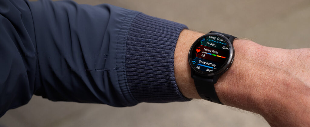 A close-up of a Garmin Venu 3 smartwatch on a person's wrist displaying health metrics, including sleep tracking, heart rate, and body battery.